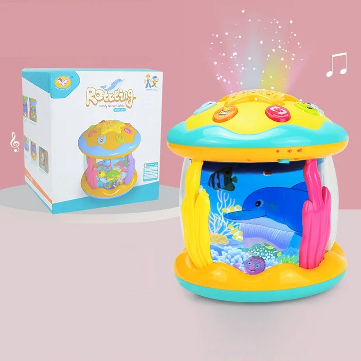 Dolphin aquarium projector toy with a yellow and turquoise top beside its retail box