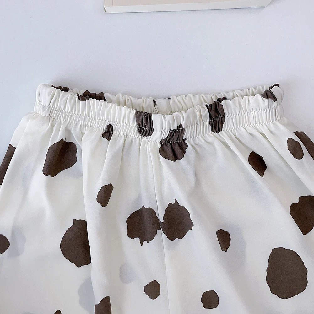 Gathered elastic waistband on white cotton bottoms with brown spots