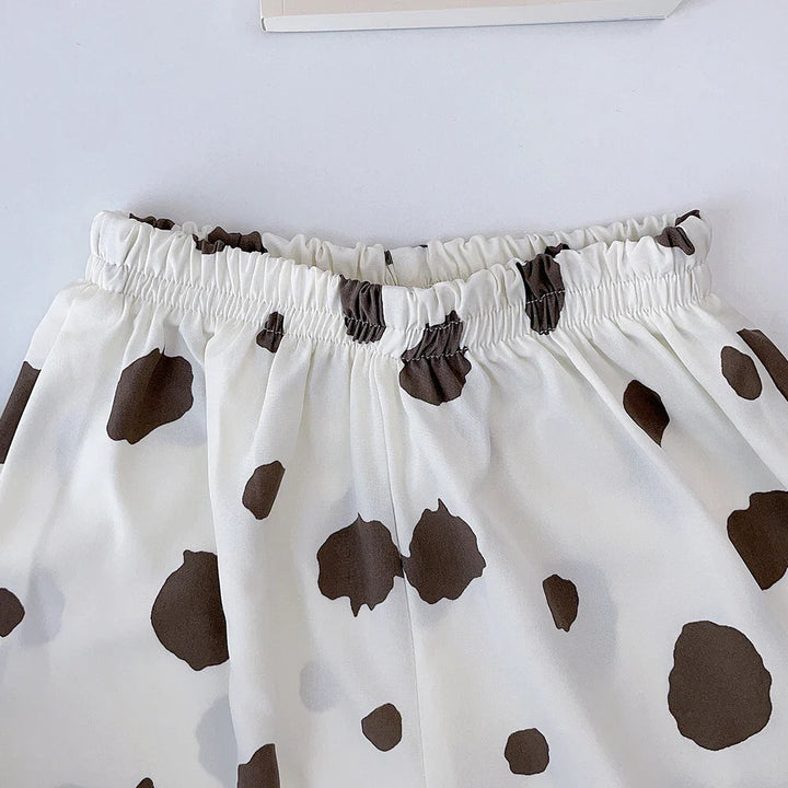 Gathered elastic waistband on white cotton bottoms with brown spots