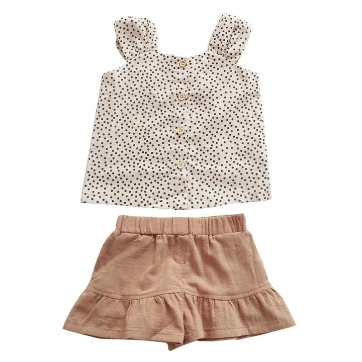Cream polka-dot button-front top and tan elastic-waist shorts shown together
