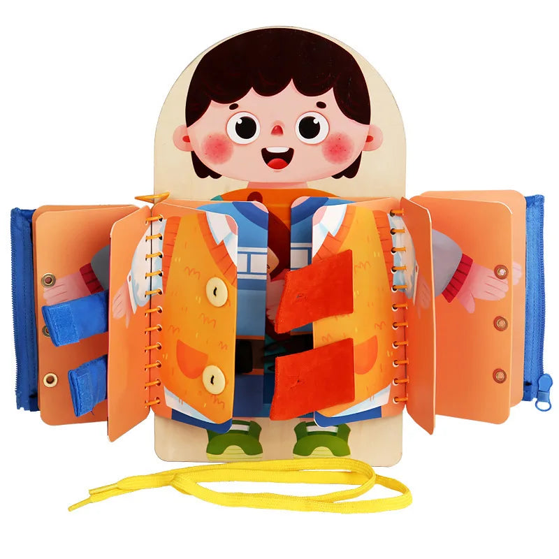 Open dress-up activity book with buttons, fabric tabs, blue zippers, and yellow laces
