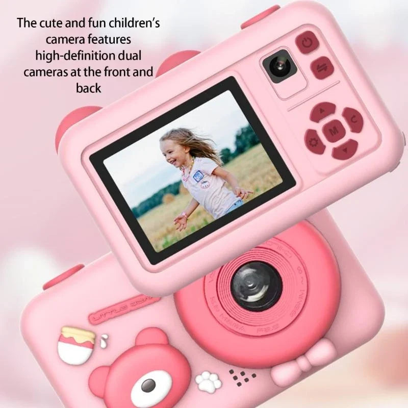 Front and rear views of the pink camera showing both lenses, the screen, and controls