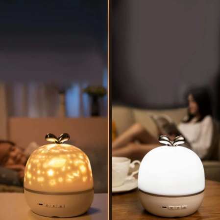 Star projector shown with warm projected patterns and a plain white night light glow