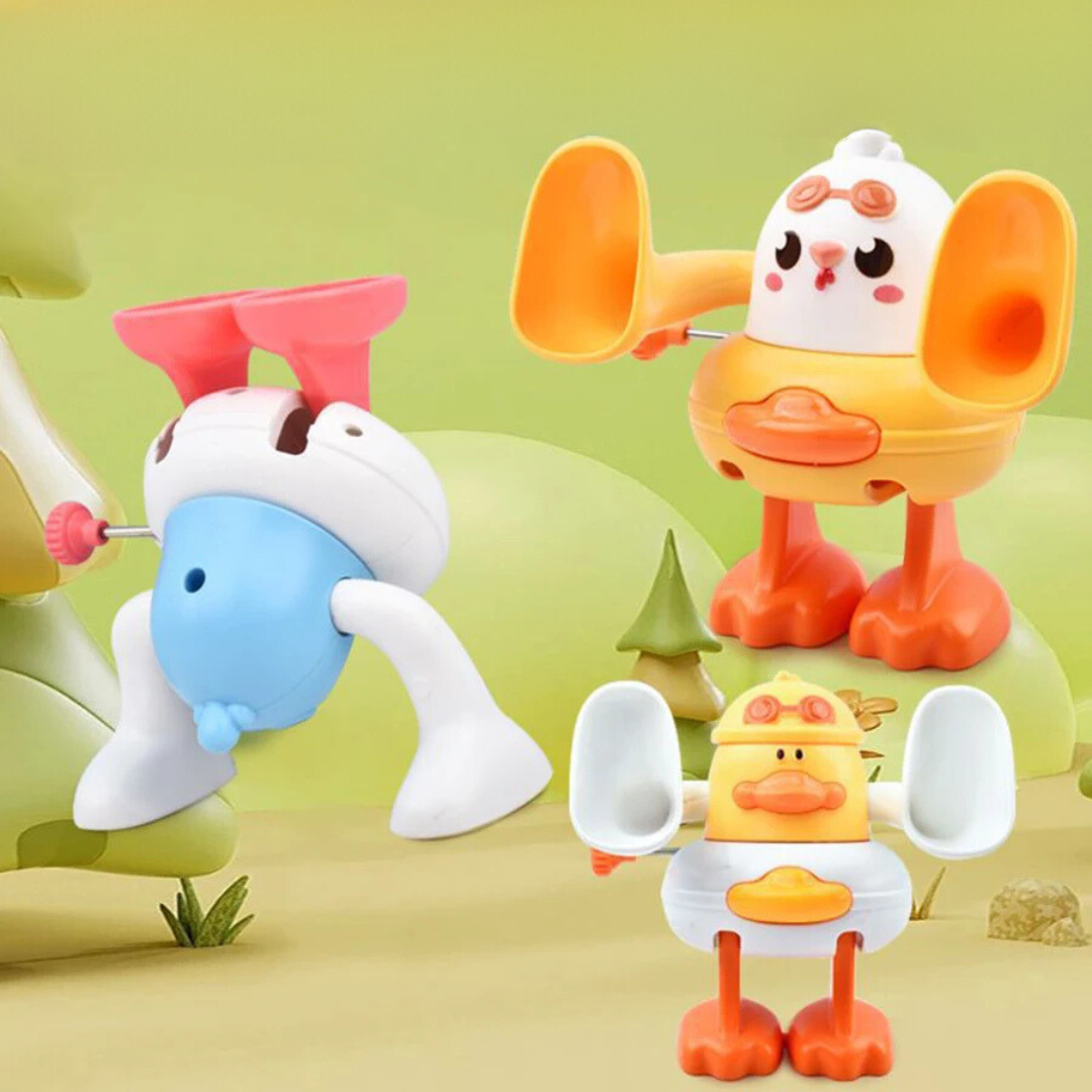 Three duck and chick flipping toys displayed upright and upside down on green platforms