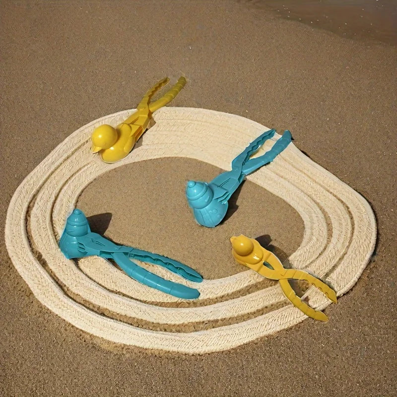 Duck and snowman mold clips arranged around a circular track in sand