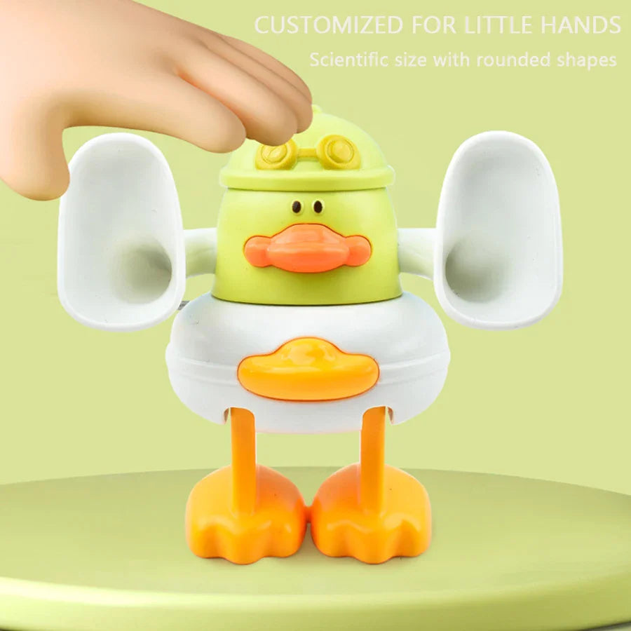 Hand grasping the top of a duck toy with rounded white wings and orange feet