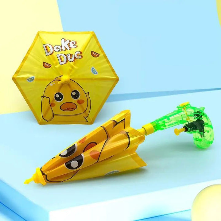 Yellow duck umbrella water gun shown with its canopy open and folded