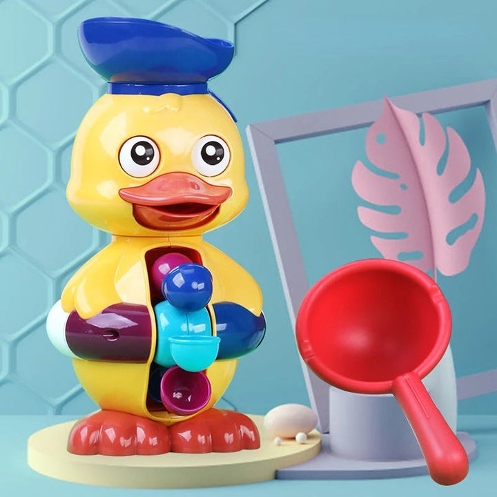 Yellow duck bath toy with a dark blue top bowl, colorful water wheel, and red scoop