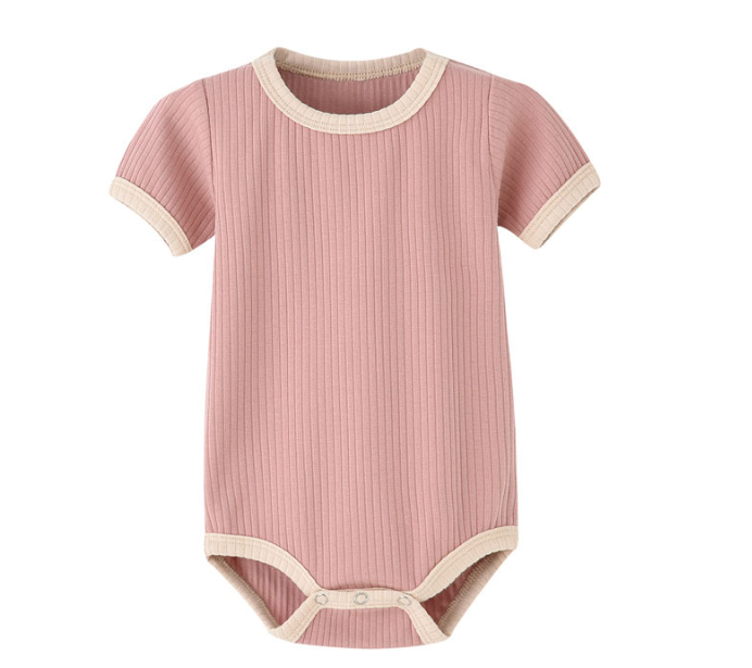 Dusty pink ribbed baby romper with cream trim and a bottom snap closure