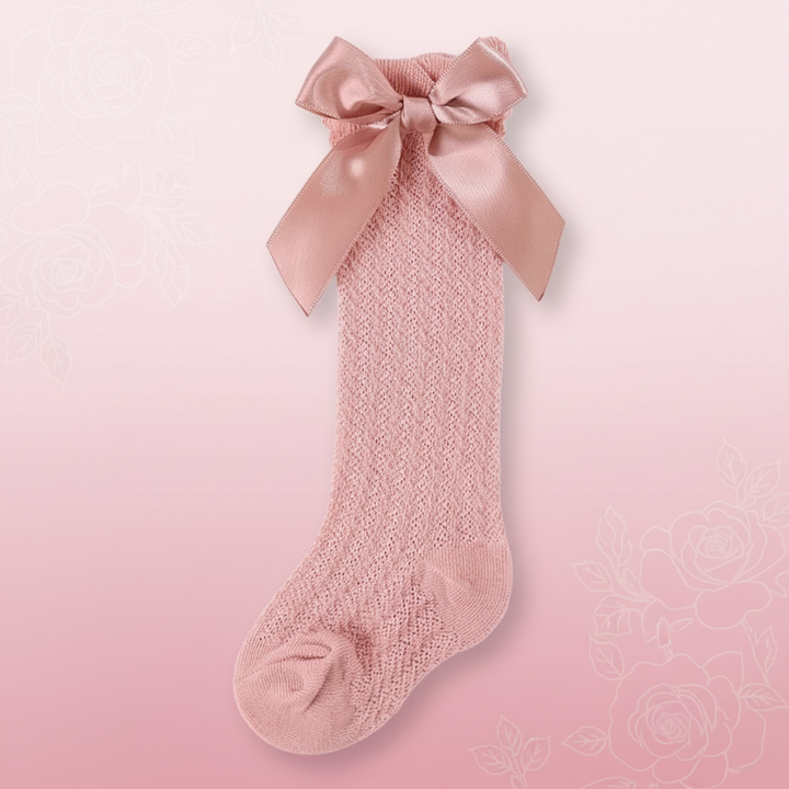 Dusty rose pointelle knee-high sock with a matching satin bow
