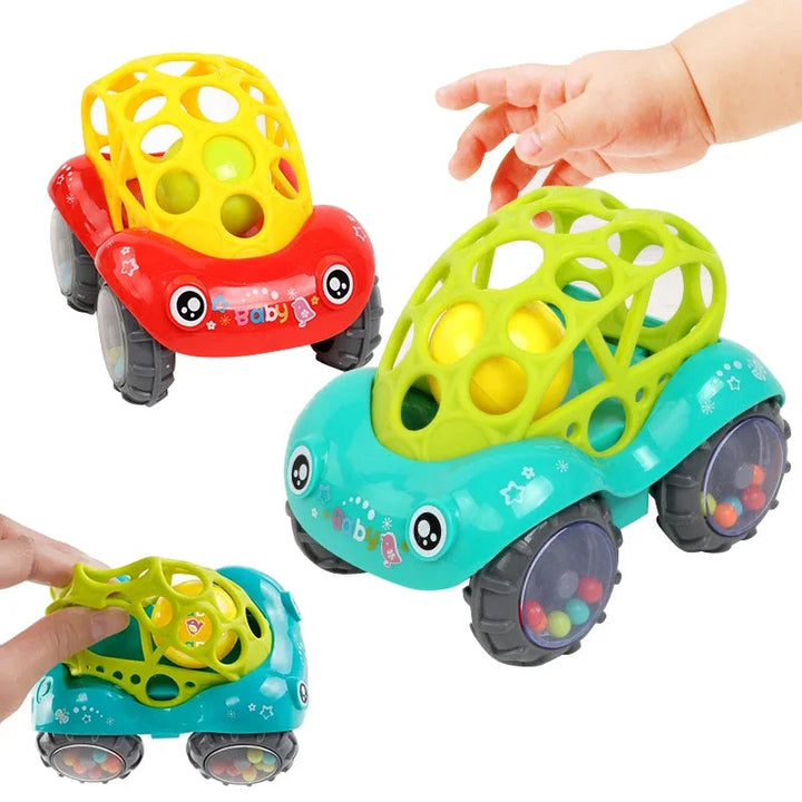Red and green rattle toy cars with a hand reaching for the green lattice top