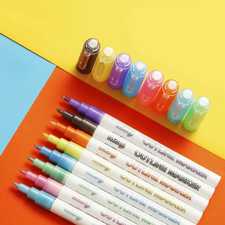 Eight outline markers and their caps on a colorful geometric background