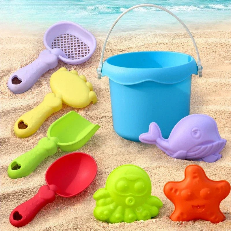8-piece beach toy set with a blue bucket, four hand tools, and whale, octopus, and starfish molds