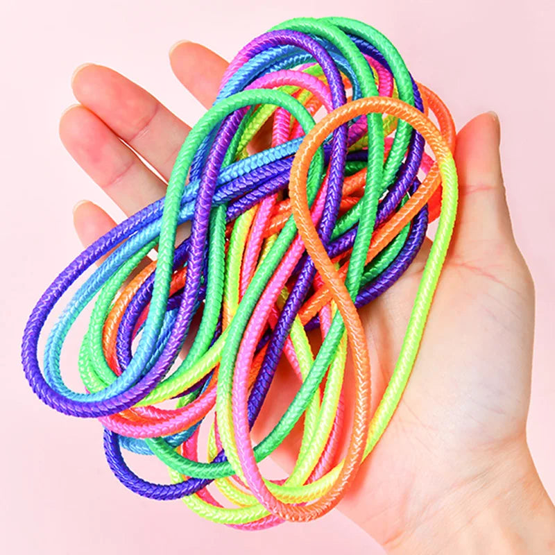 Hand holding a loosely gathered multicolor jump band