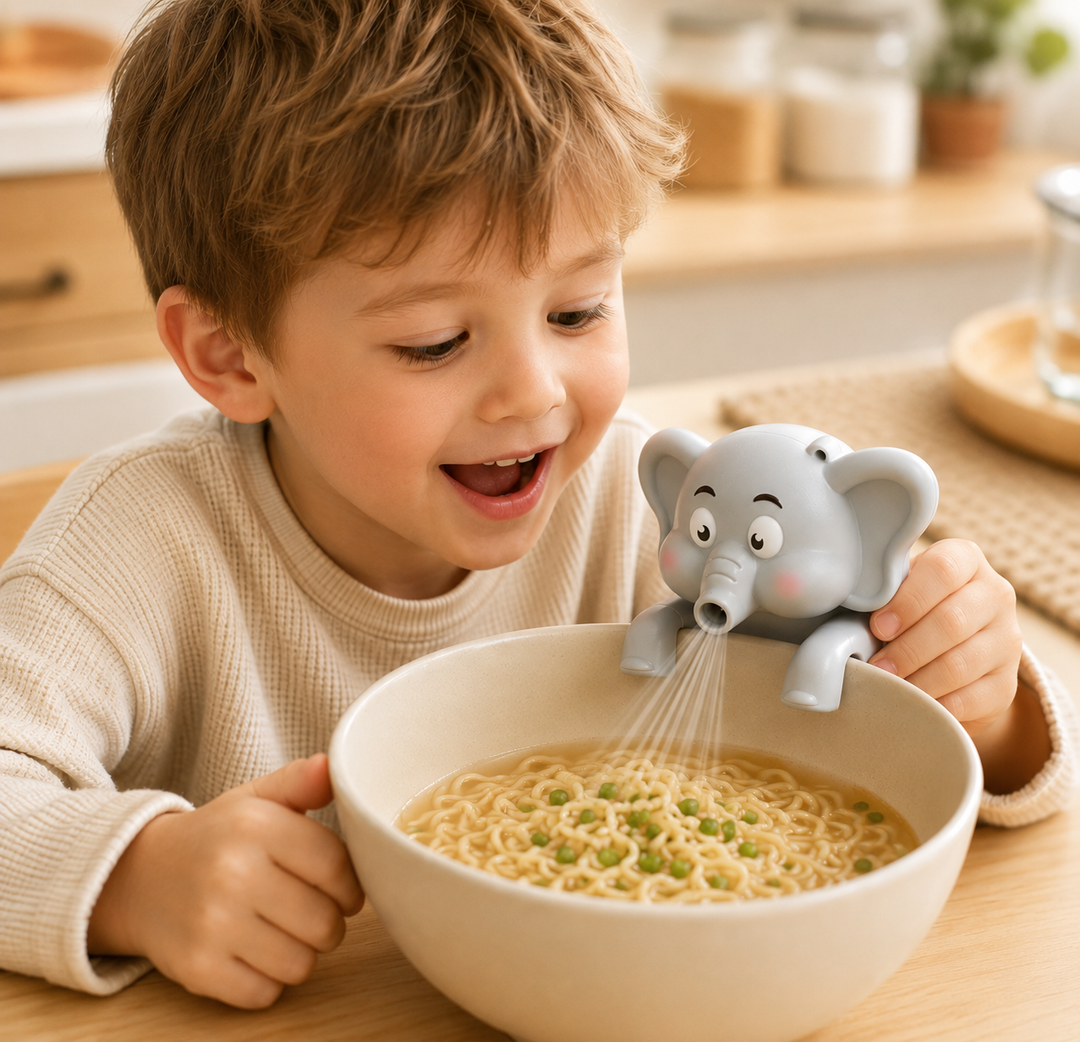 Child beside a noodle bowl with an elephant food cooling fan resting on the rim