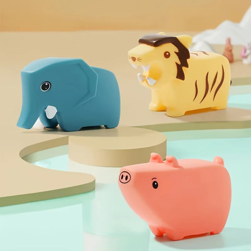 Blue elephant, yellow striped cat, and pink pig bath toys on display
