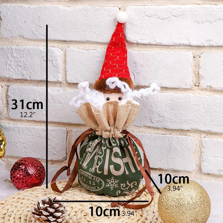 Green elf Christmas gift bag with a tall red hat and measurements of 31 × 10 × 10 cm.
