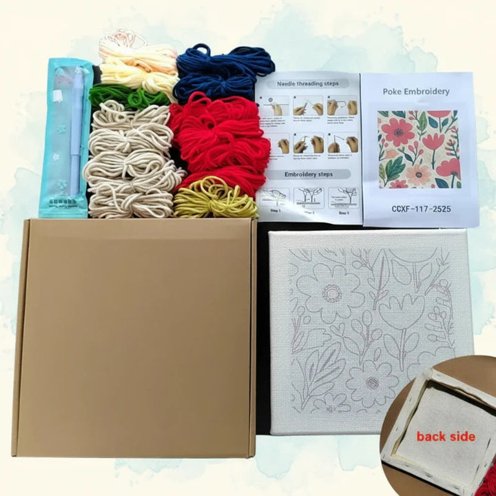 Embroidery kit supplies with colorful yarn, printed fabric, instructions, and a box.