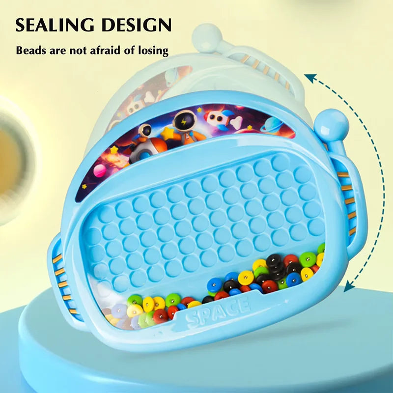 Blue magnetic drawing board with enclosed beads gathered along the bottom