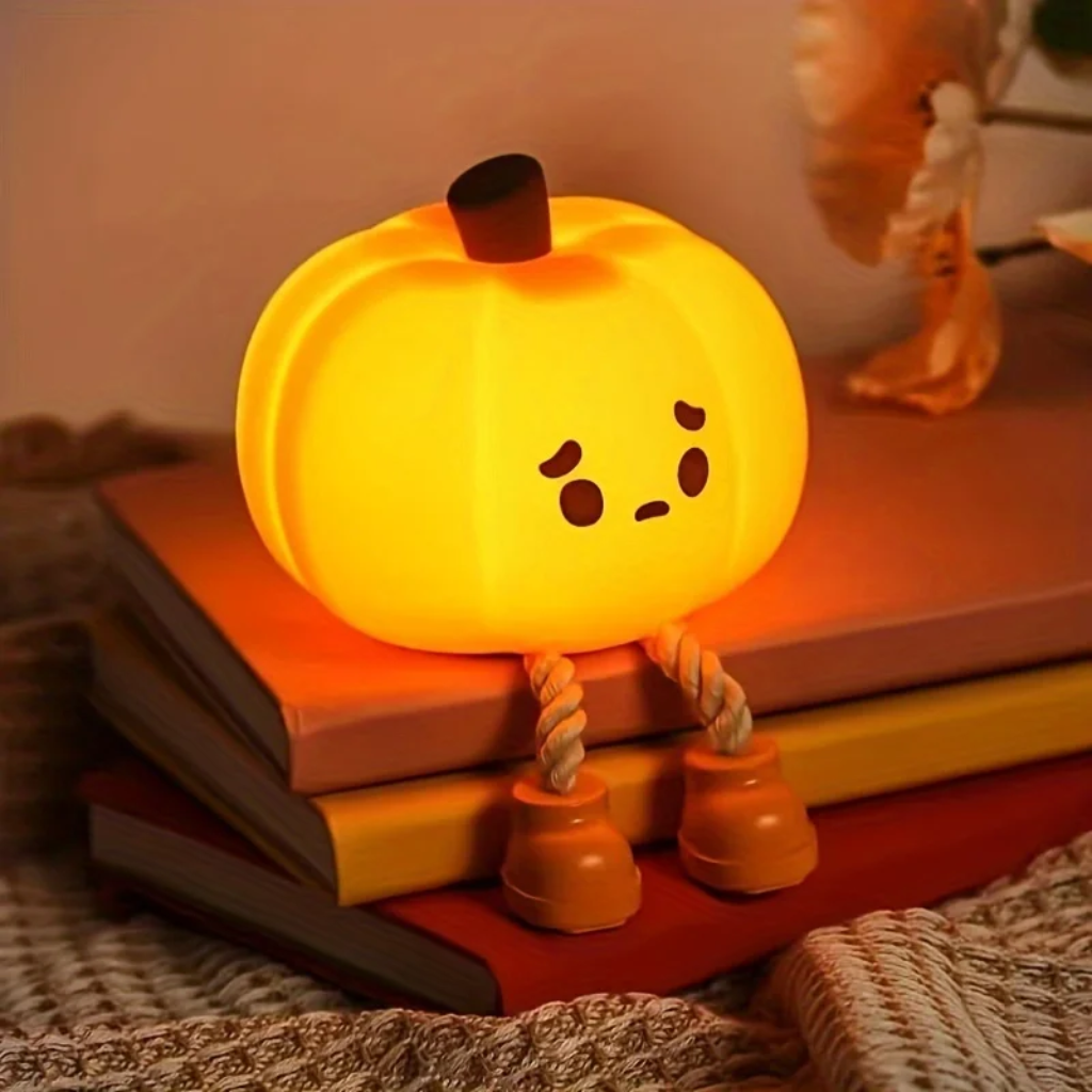 Cute pumpkin night light with a worried expression and dangling legs
