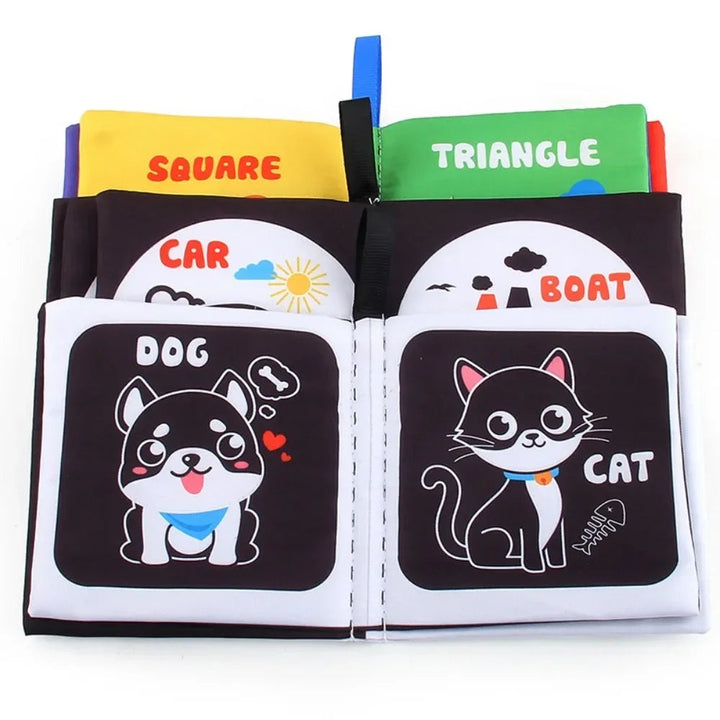 Open fabric books with dog and cat illustrations in front of vehicle and shape pages