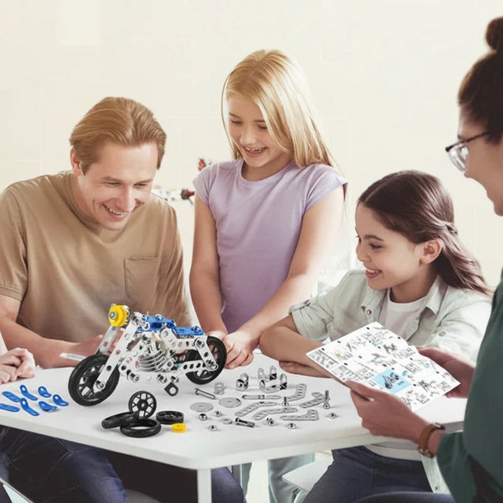 A family building a blue motorcycle model with an instruction booklet and loose construction parts