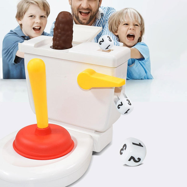 An adult and two children reacting behind a toilet game with the pretend poop piece raised