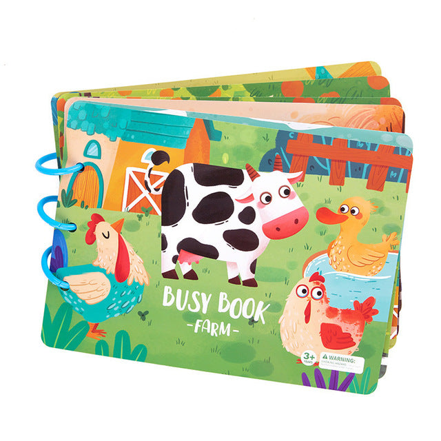 Farm animal activity book with a cow and chickens on the cover and blue binding rings