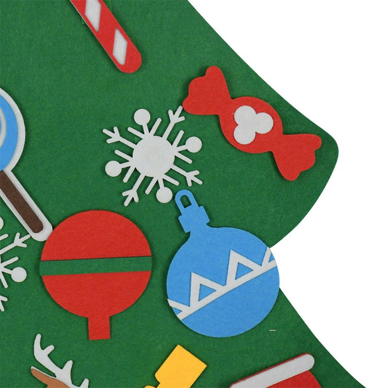 Close-up of felt candy, snowflake and round bauble decorations on the green tree