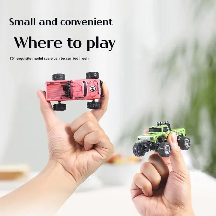 Mini RC trucks balanced on fingertips to demonstrate their compact size.