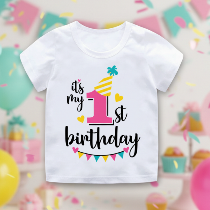 White first-birthday T-shirt with a pink number 1, yellow party hat, and colorful bunting