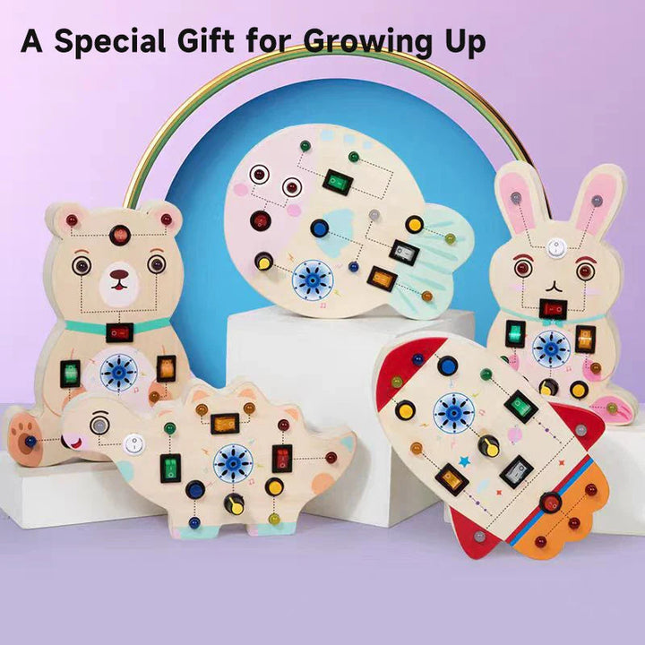 Five wooden LED activity board designs arranged beneath a rainbow