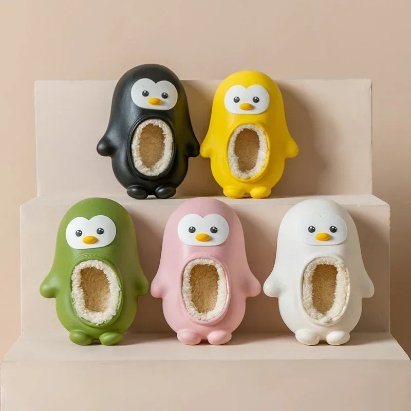 Penguin slippers in black, yellow, green, pink, and white arranged on stepped shelves