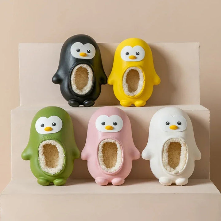 Penguin slippers in black, yellow, green, pink, and white arranged on stepped shelves