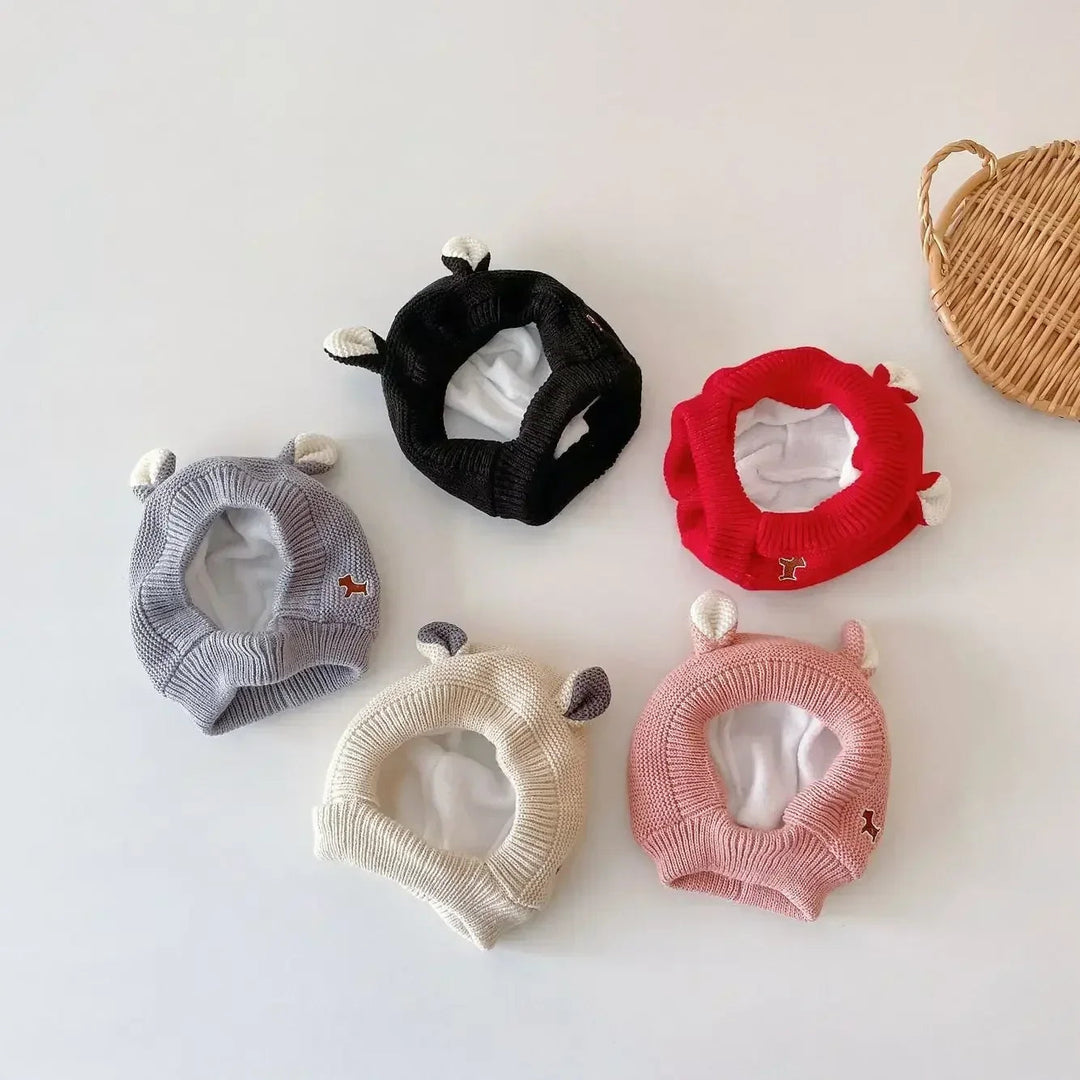 Gray, black, red, beige, and pink ear-topped balaclava hats laid flat