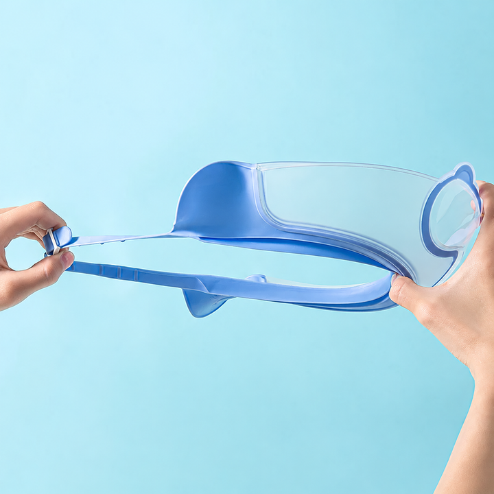 Hands stretching the blue shower cap band to show its flexibility