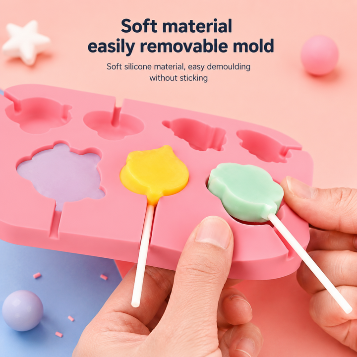 A hand releasing a pastel lollipop from a flexible pink silicone mold