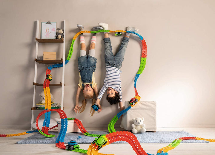 Multicolor flexible race track arranged around a ladder and bedroom furniture