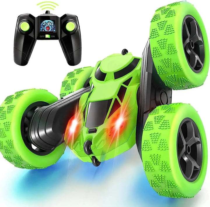 Green RC stunt car with oversized treaded wheels and a wireless remote