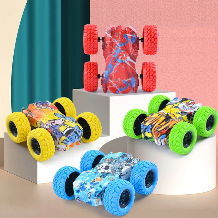 Red, yellow, green, and blue double-sided toy cars displayed on blocks.