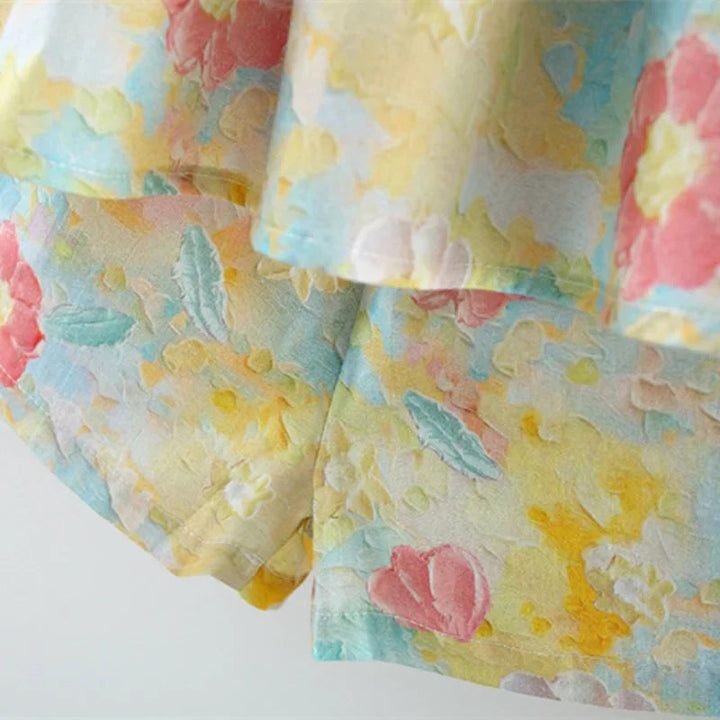 Flared floral top hem above matching baby shorts