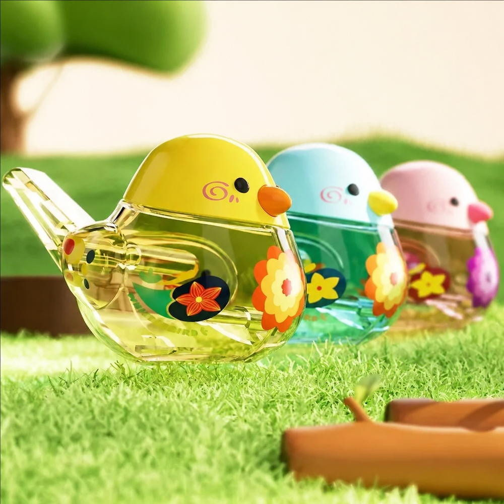 Yellow, blue, and pink-and-purple bird whistles with transparent floral bodies on grass