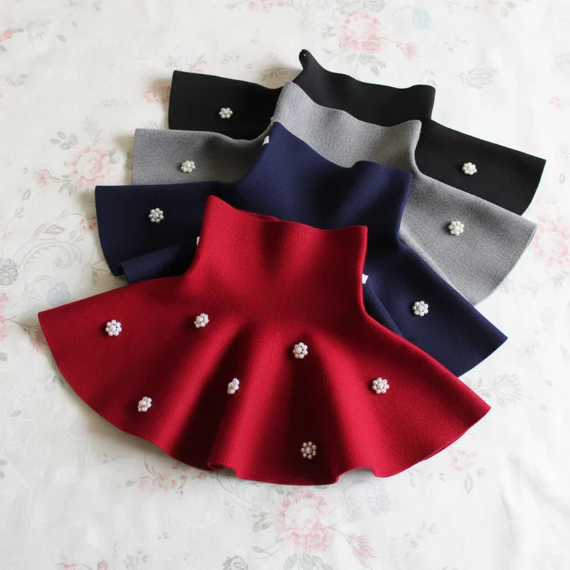 Red, navy, gray, and black flared knit skirts with flower-shaped bead accents