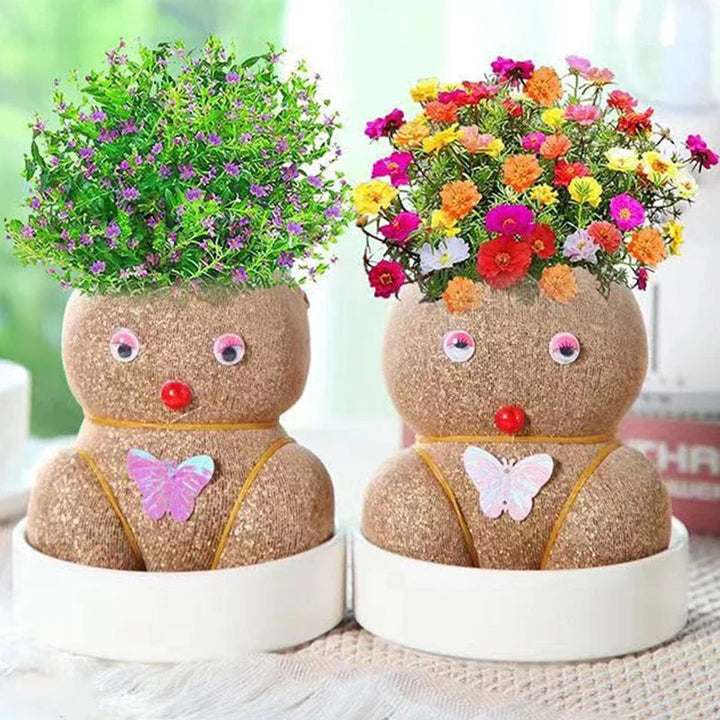Two flower-topped growing figures with butterfly decorations in white bowls
