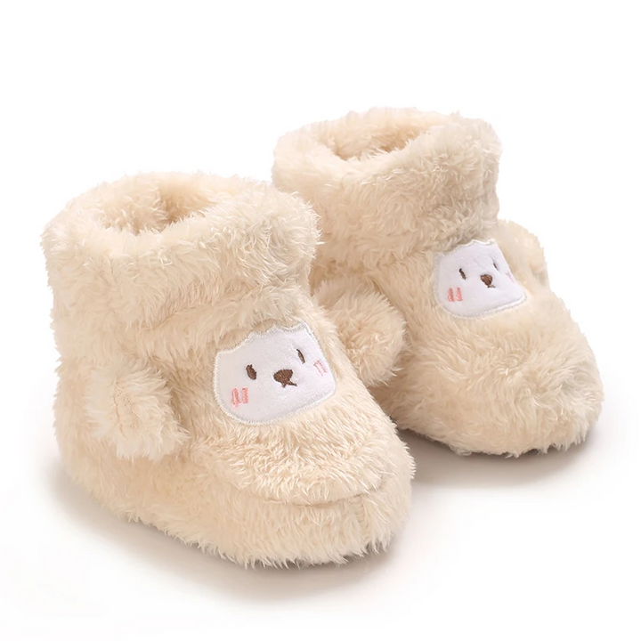 Fluffy cream baby boots with bear-face patches on the toes
