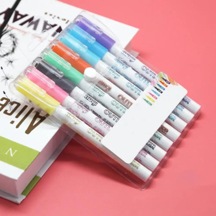 Fluorescent outline markers in a clear case on a pink background