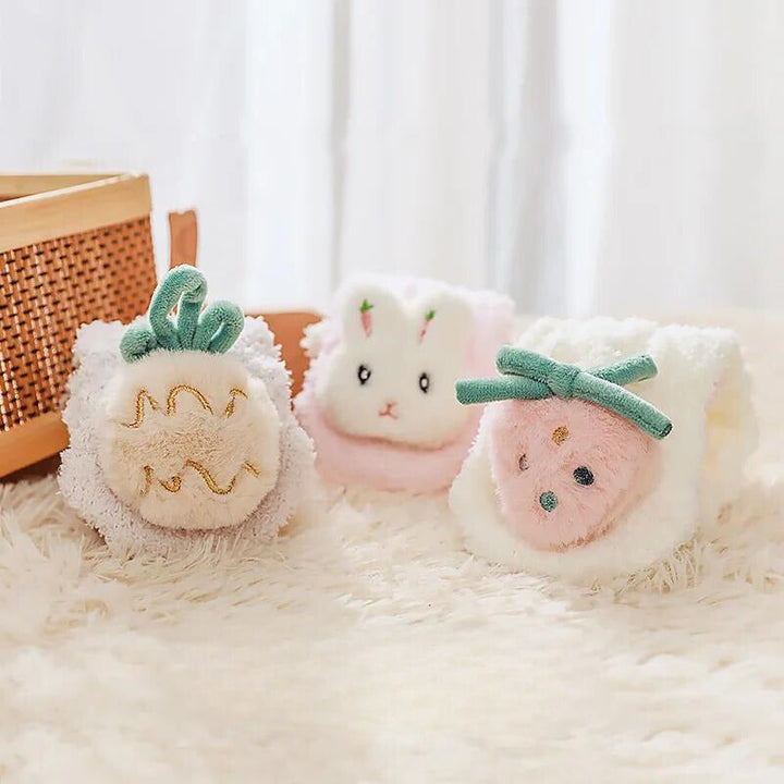 Folded pineapple, rabbit, and strawberry socks showing their raised decorations