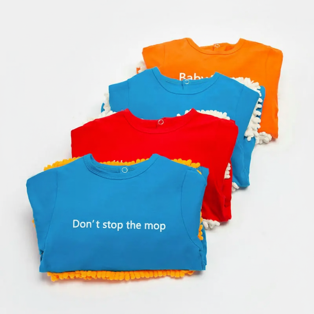 Folded baby jumpsuits in blue, red, and orange with printed chest slogans