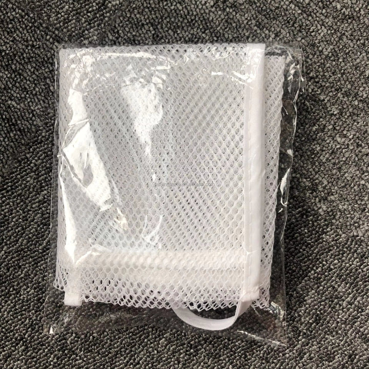 Folded white mesh bath organizer inside clear packaging