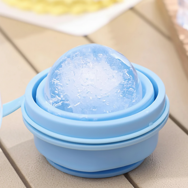 Folded blue silicone cup holding a large round piece of ice